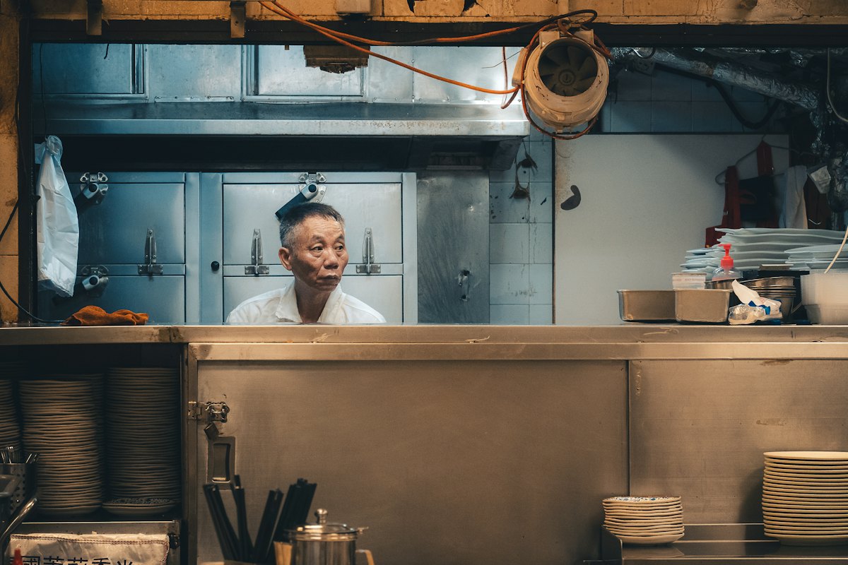 Restaurant owner at the pass of his kitchen