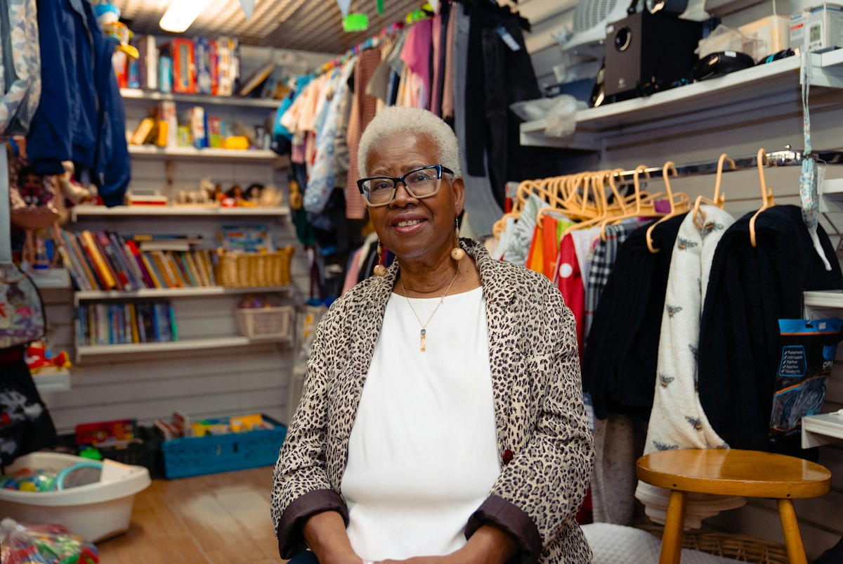 Shop owner sitting in her clothing store